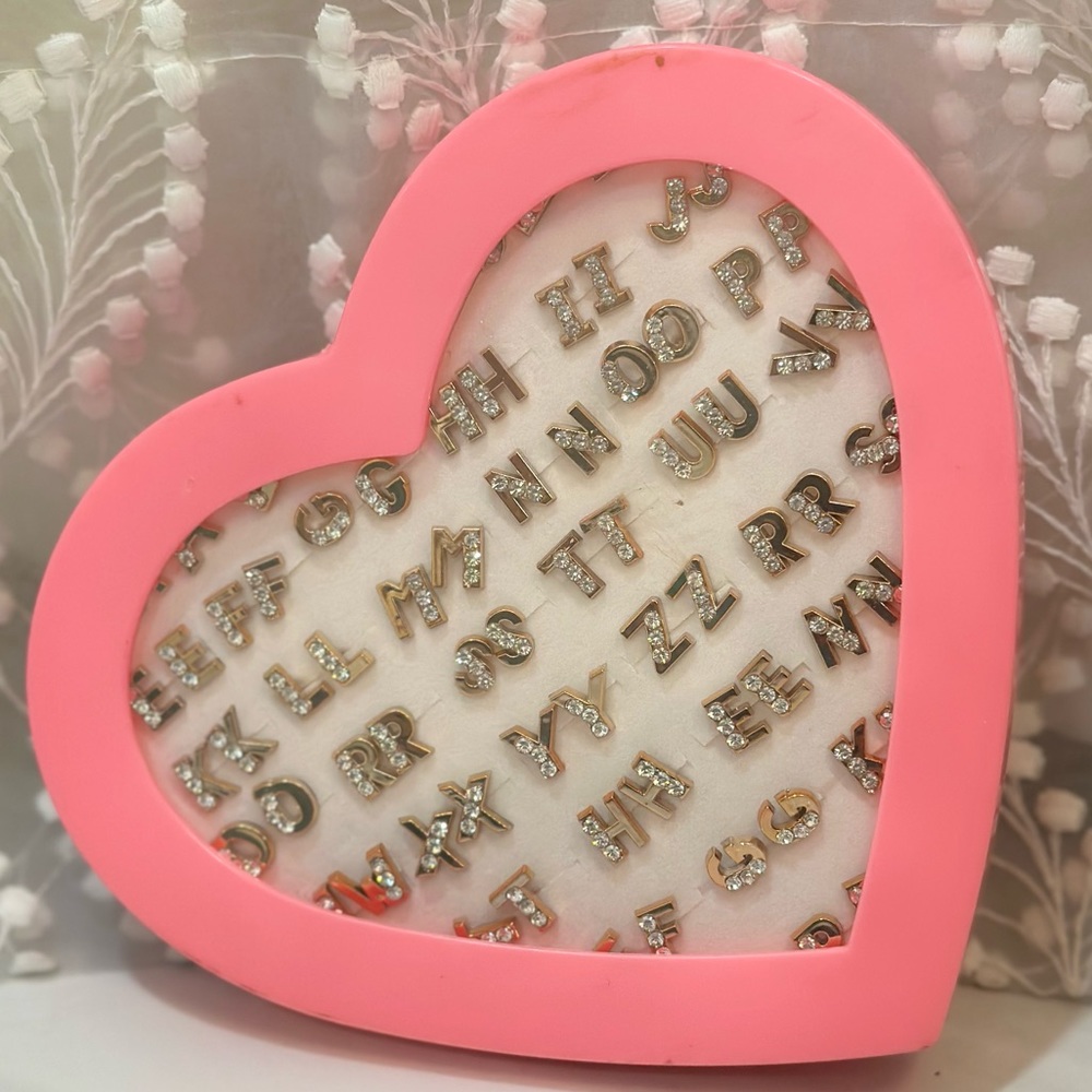 A-Z gold stud earrings with pink heart container
